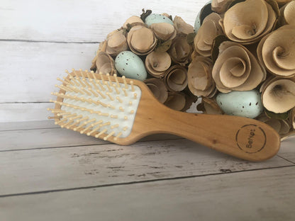 Violet Atlas wooden detangling hair brush with ergonomic handle, gentle teeth for smooth, tangle-free hair care in bath and beauty routine