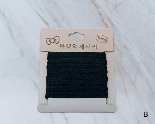 Azure Thanatos Francesca No Pull Hair Scrunchy in soft fabric, styled around hair for gentle hold and stylish accessory.