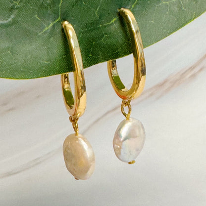 Fuchsia Hercules gold hoop earrings with dangling pearls, stylish jewelry piece featuring elegant pearl accents and hoop design.