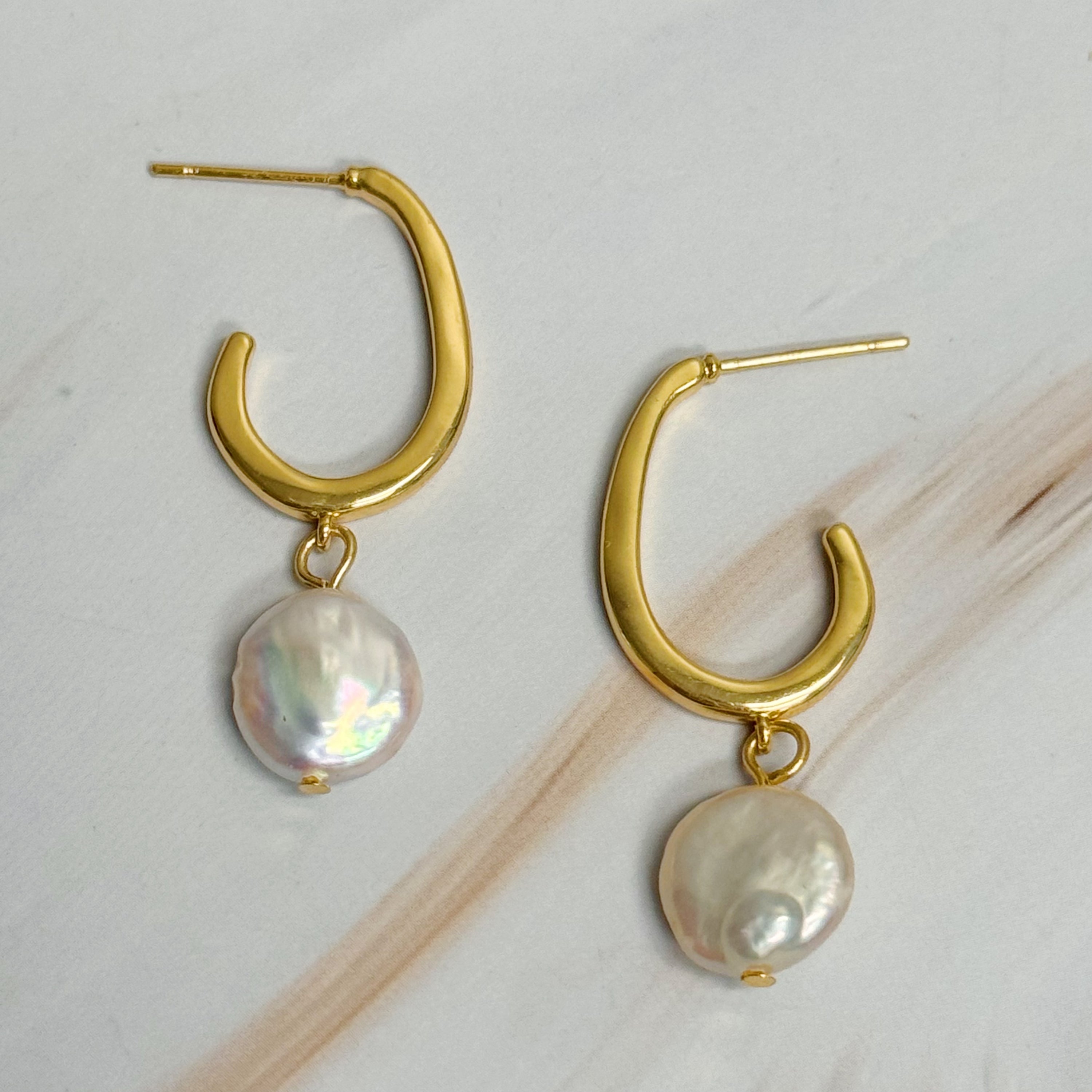 Fuchsia Hercules dangle pearl gold hoop earrings with elegant pearl accents and shiny gold hoops for jewelry and watches.