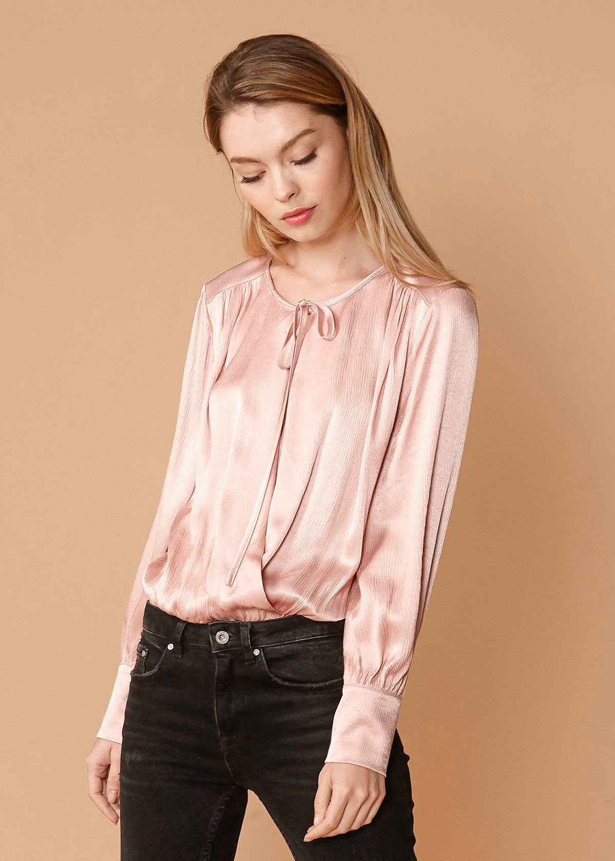 Lemon Hera fall pink tie-neck long sleeve bodysuit with fitted design and button closure at the crotch.