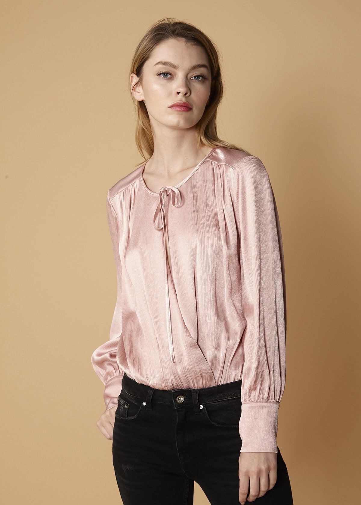 Lemon Hera fall pink tie-neck long sleeve bodysuit with fitted silhouette and button closure at the crotch.