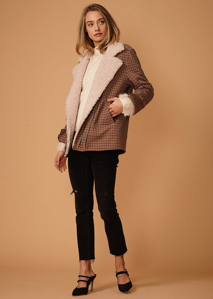 Asymmetrical peach gingham zip-front coat by Lemon Hera, stylish jackets and coats with a modern design and playful pattern.