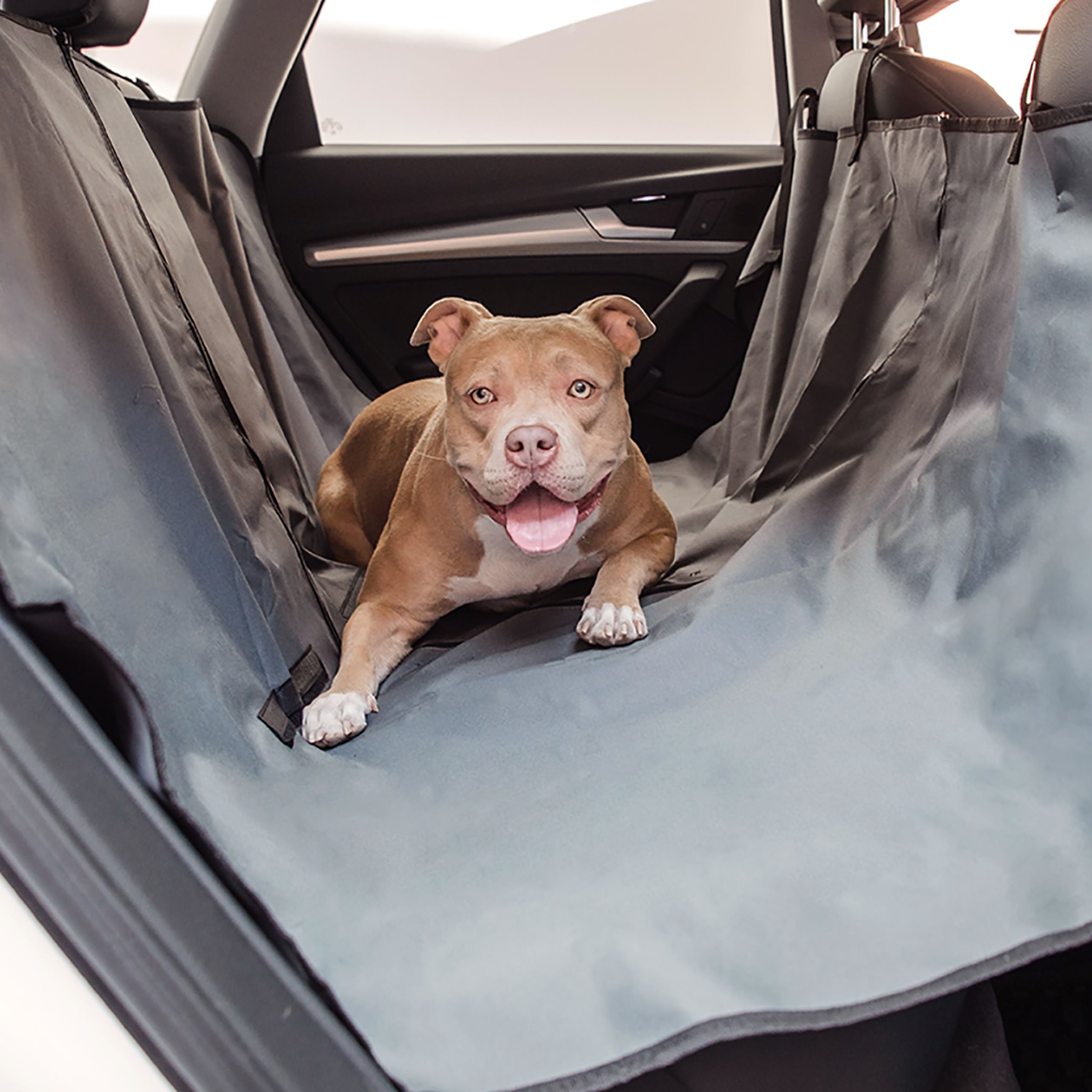 Beige Antigone pet hammock seat cover with mesh sides, designed to protect car seats from pet fur and dirt during travel.