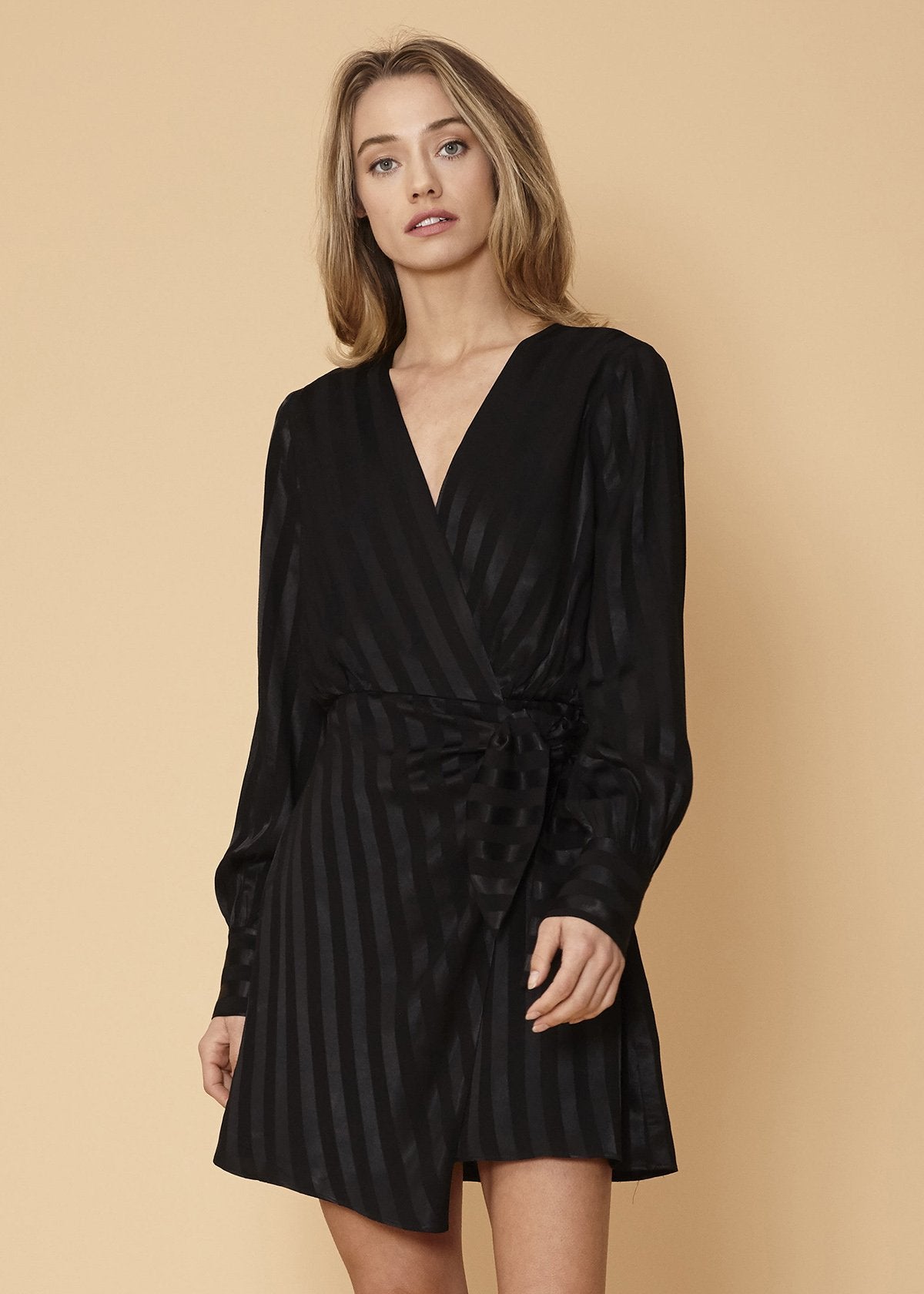 Black satin long sleeve mini dress by Lemon Hera featuring stripe pattern and elegant design.