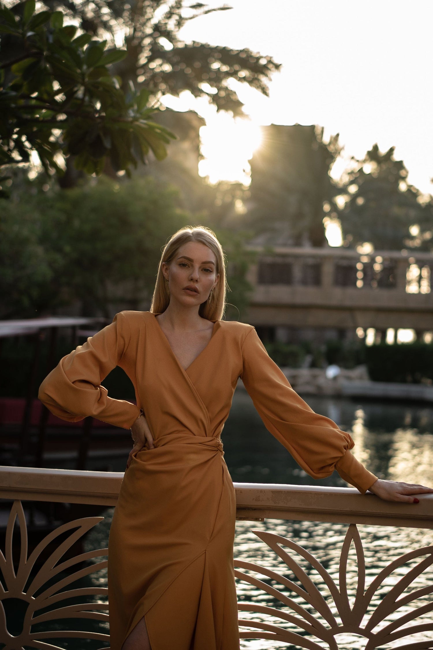 Blush Athena mustard wrap maxi dress displayed on a model, featuring a flowing silhouette and elegant design.