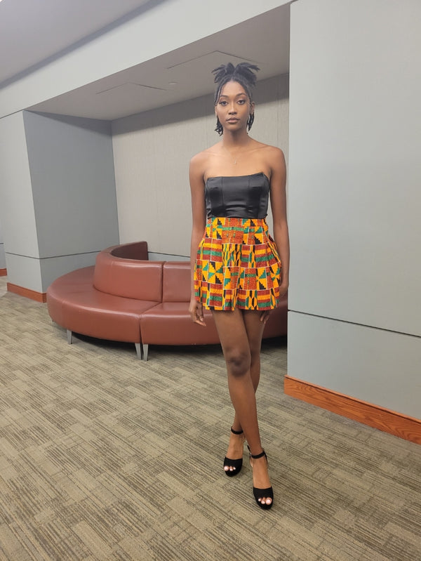 White Baobab African mini Kente skirt styled as a summer T-shirt, featuring vibrant Kente fabric and casual summer wear design.