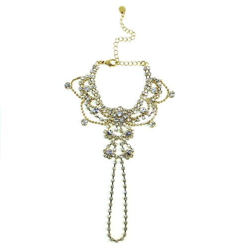 Gold draping crystals handpiece bracelet by Cyan Ismene featuring intricate crystal embellishments and elegant hand chain design.