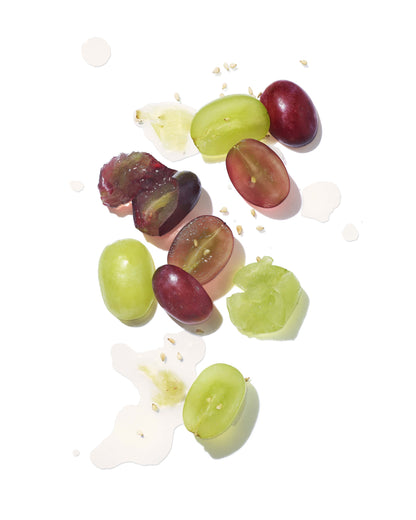 Green Saffron Mekabu hydrating styling cream for hair, shown with grapes, highlighting natural ingredients and nourishing formula.