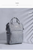 Modern quilted diaper bag backpack for kids and babies by Maroon Chronos, featuring multiple pockets and comfortable straps.