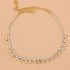Red Iphigenia barefoot chain bracelet on leg, stylish jewelry and watch accessory for beach or casual wear.