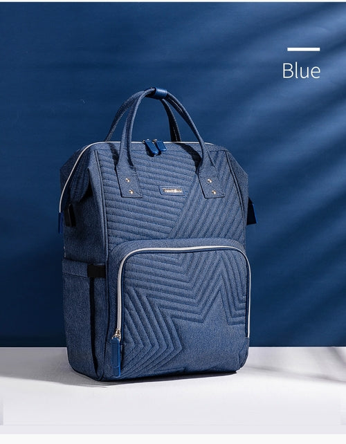 Modern quilted diaper bag backpack by Maroon Chronos with multiple pockets and adjustable straps for kids and babies.