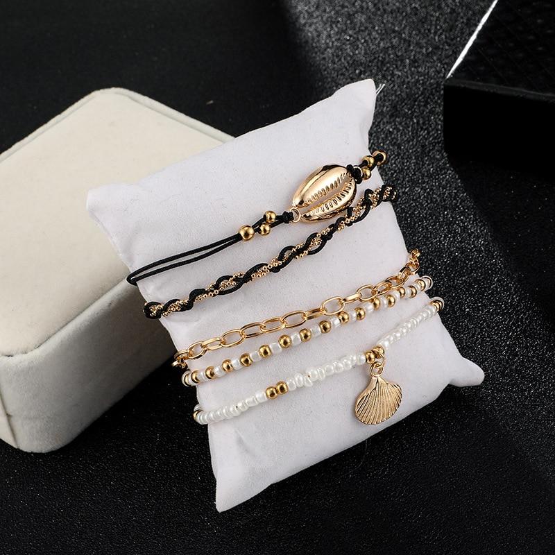 Multi-layered gold shell pendant chains ankle bracelet by Coffee Jasper featuring layered gold chains and shell charms.