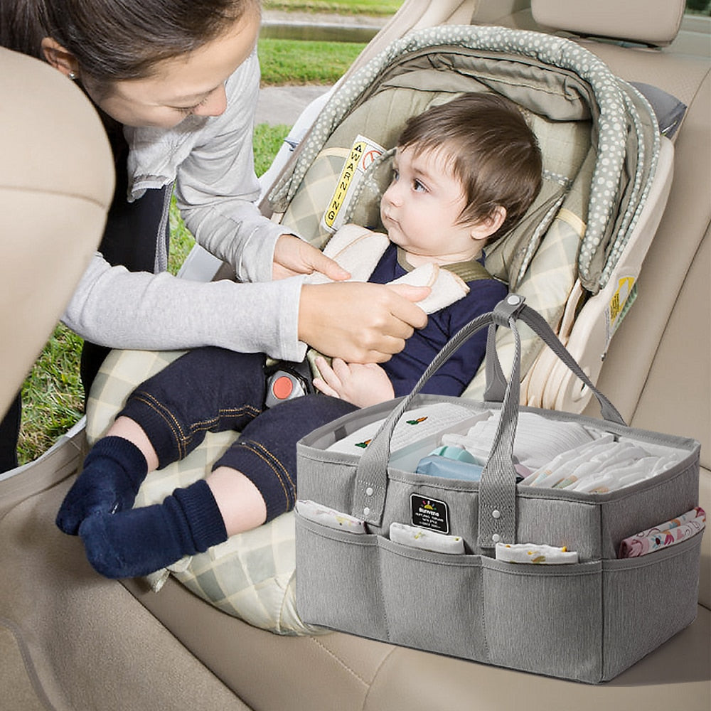 Maroon Chronos diaper caddy in kids and babies diaper organizers, with compartments holding baby essentials and toiletries.