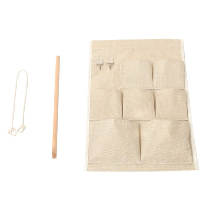 Maroon Asteria door wall bedside organizer bag with 7 pockets, ideal for toys and small essentials, hanging on a door.