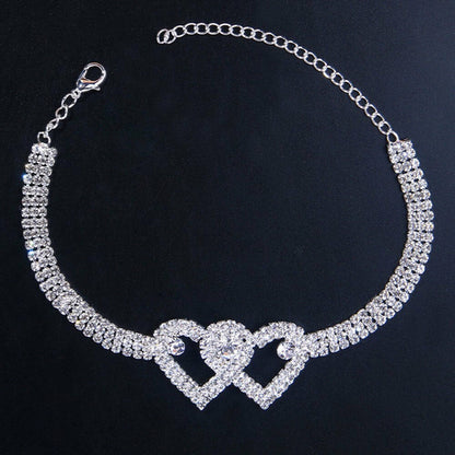 Red Iphigenia double heart anklet bracelet for women, beach jewelry with adjustable chain and heart charms on ankle.