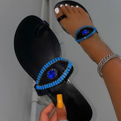 Coffee Jasper female rhinestone eyes slides featuring round toe flat slippers with sparkling rhinestone details.