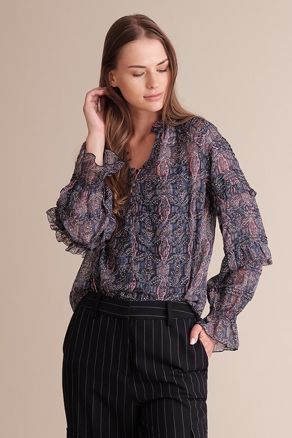 Viridian Smokey Kiara raglan sleeve pleated blouse in ultra violet navy with colorful pattern, displayed on a hanger.