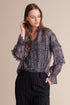 Viridian Smokey Kiara raglan sleeve pleated blouse in ultra violet navy with colorful pattern, displayed on a hanger.
