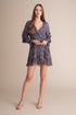 Viridian Smokey Kenzie wrap front mini dress in ultra violet navy with multi-colored details, styled with a vibrant, bohemian look.