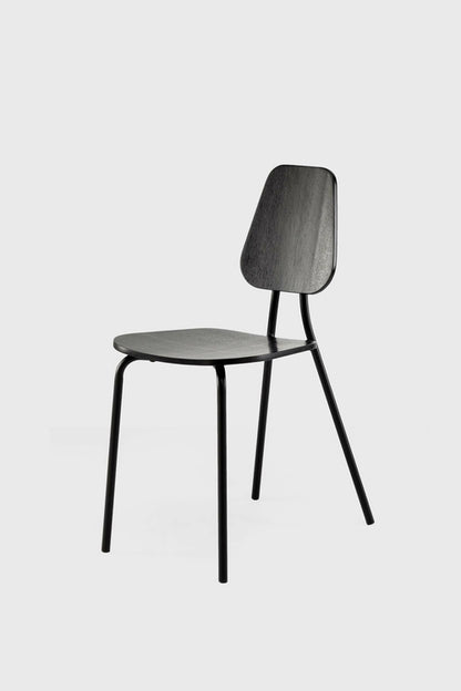 Black Hoya chair by Aquamarine Poppy featuring sleek wooden legs and modern furniture design.