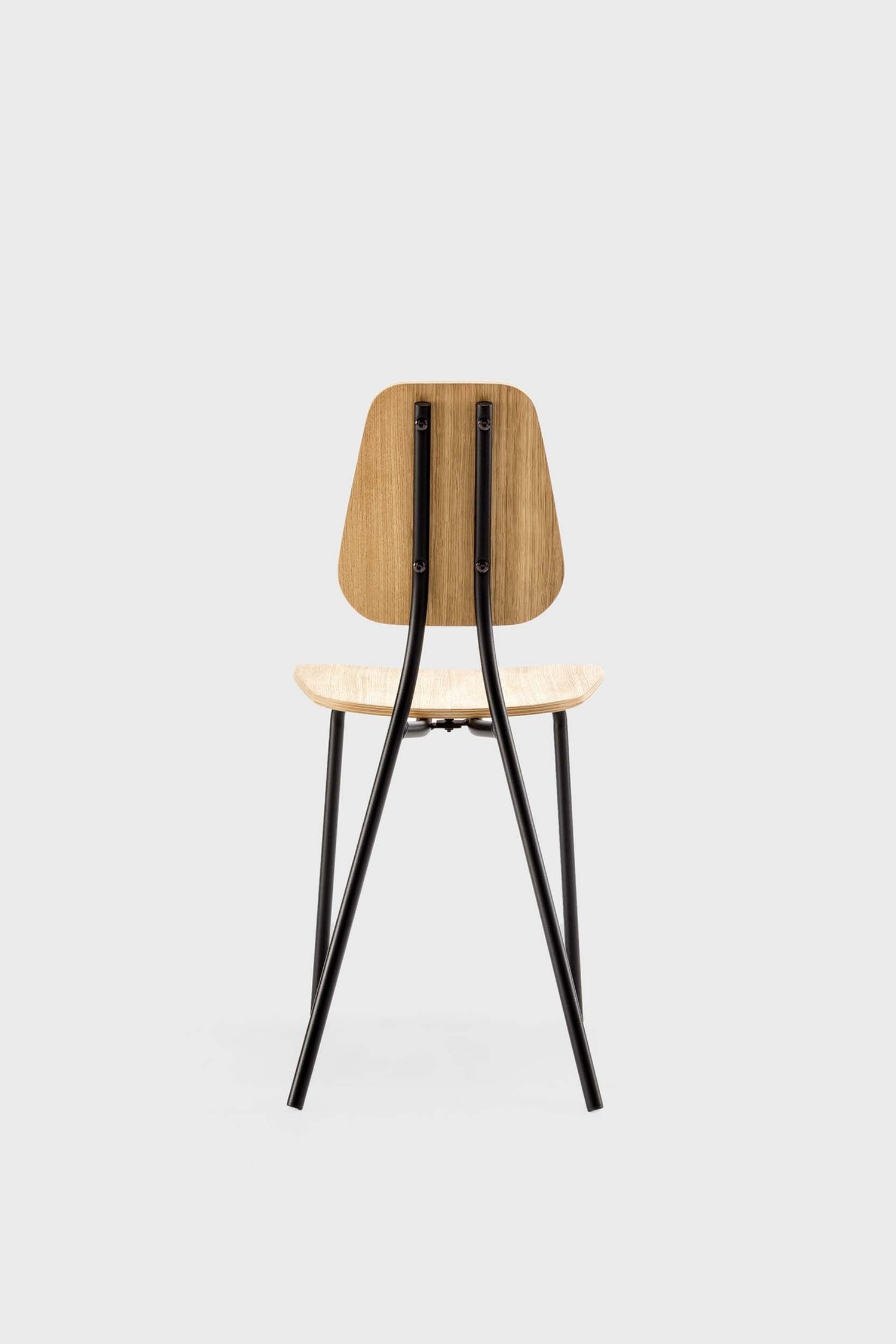 Aquamarine Poppy Hoya Chair in oak finish, modern furniture piece with a sleek design and wooden frame, photographed from a side view.