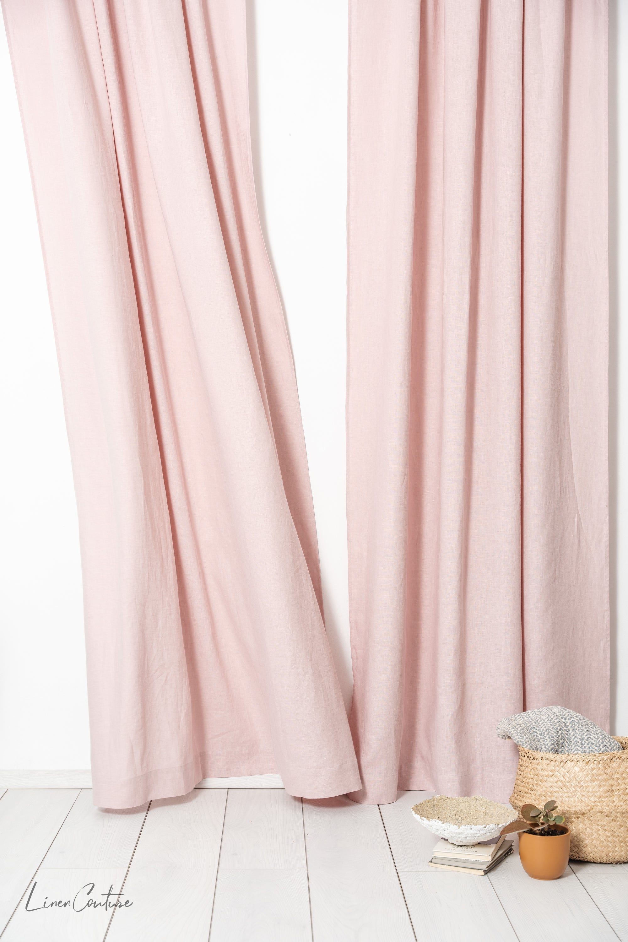 Pale pink linen curtain with tab tops, stylish home decor by Magenta Sugarplum, hanging on a window with natural light.