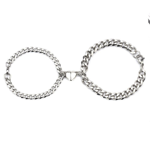 Silver Juneberry stainless steel couple bracelets with magnetic heart charms and Cuban chain design, stylish and romantic jewelry.