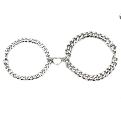 Silver Juneberry stainless steel couple bracelets with magnetic heart charms and Cuban chain design, stylish and romantic jewelry.