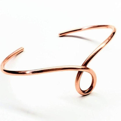 Handmade sculpted copper teardrop bangle bracelet with intricate design by Blue Crius, showcasing artisanal craftsmanship.