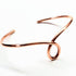 Handmade sculpted copper teardrop bangle bracelet with intricate design by Blue Crius, showcasing artisanal craftsmanship.