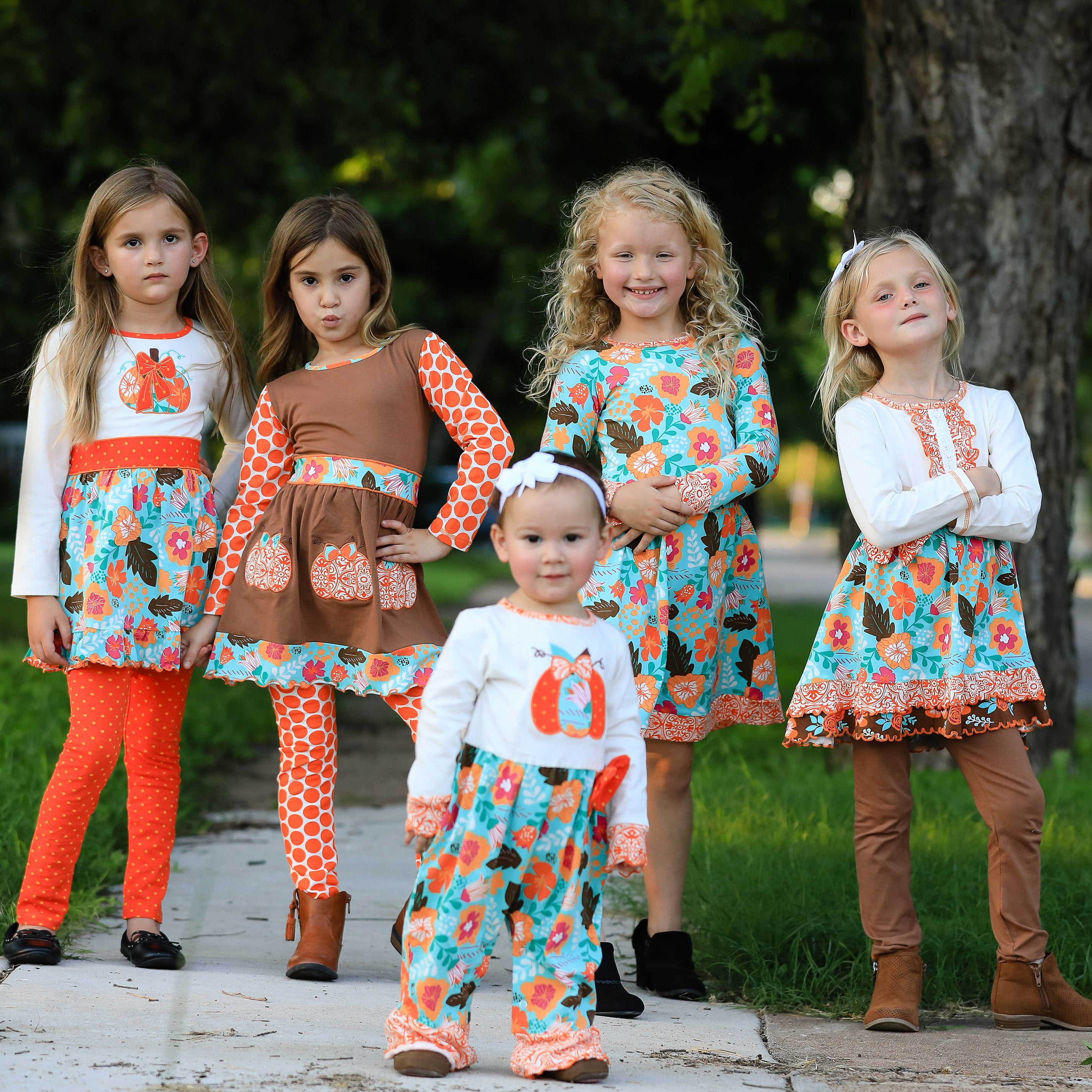Black Simba AnnLoren toddler girl pumpkin romper with orange autumn pumpkin print, suitable for Thanksgiving and fall celebrations.