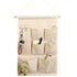 Maroon Asteria door wall bedside organizer bag with 7 pockets for toys, hanging on a wall for convenient storage.