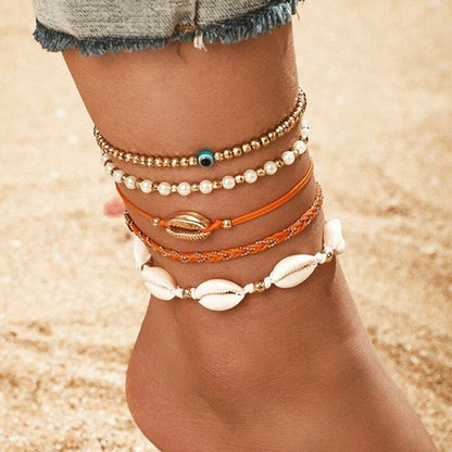 Multi-layered gold shell pendant ankle bracelet by Coffee Jasper featuring delicate chain layers and a stylish shell charm.