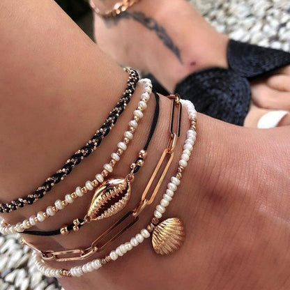 Multi-layered gold shell pendant chains ankle bracelet with intricate designs, stylish jewelry by Coffee Jasper.