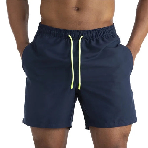 Raspberry Eurybia Sunga beach shorts swimwear with colorful pattern, displayed on a model for stylish beach or poolside wear.