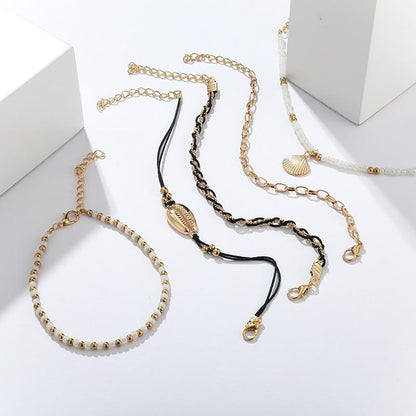Multi-layered gold shell pendant chains ankle bracelet by Coffee Jasper featuring layered design and delicate chain details.