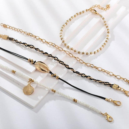 Multi-layered gold shell pendant chains ankle bracelet by Coffee Jasper, featuring layered gold chains and shell charms.