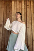 Salmon Arrowwood Bloomara top for women, featuring a stylish, fitted design with a V-neck and short sleeves, displayed on a mannequin.