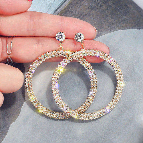Elegant diamond hoop earrings by Blush Bella featuring sparkling round-cut diamonds in a classic hoop design.