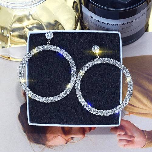 Shiny diamond hoop earrings from Blush Bella jewelry collection, featuring elegant round hoops with sparkling diamonds.