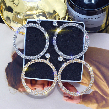 Shiny diamond hoop earrings from Blush Bella, showcasing elegant jewelry design with sparkling diamonds in a classic hoop style.