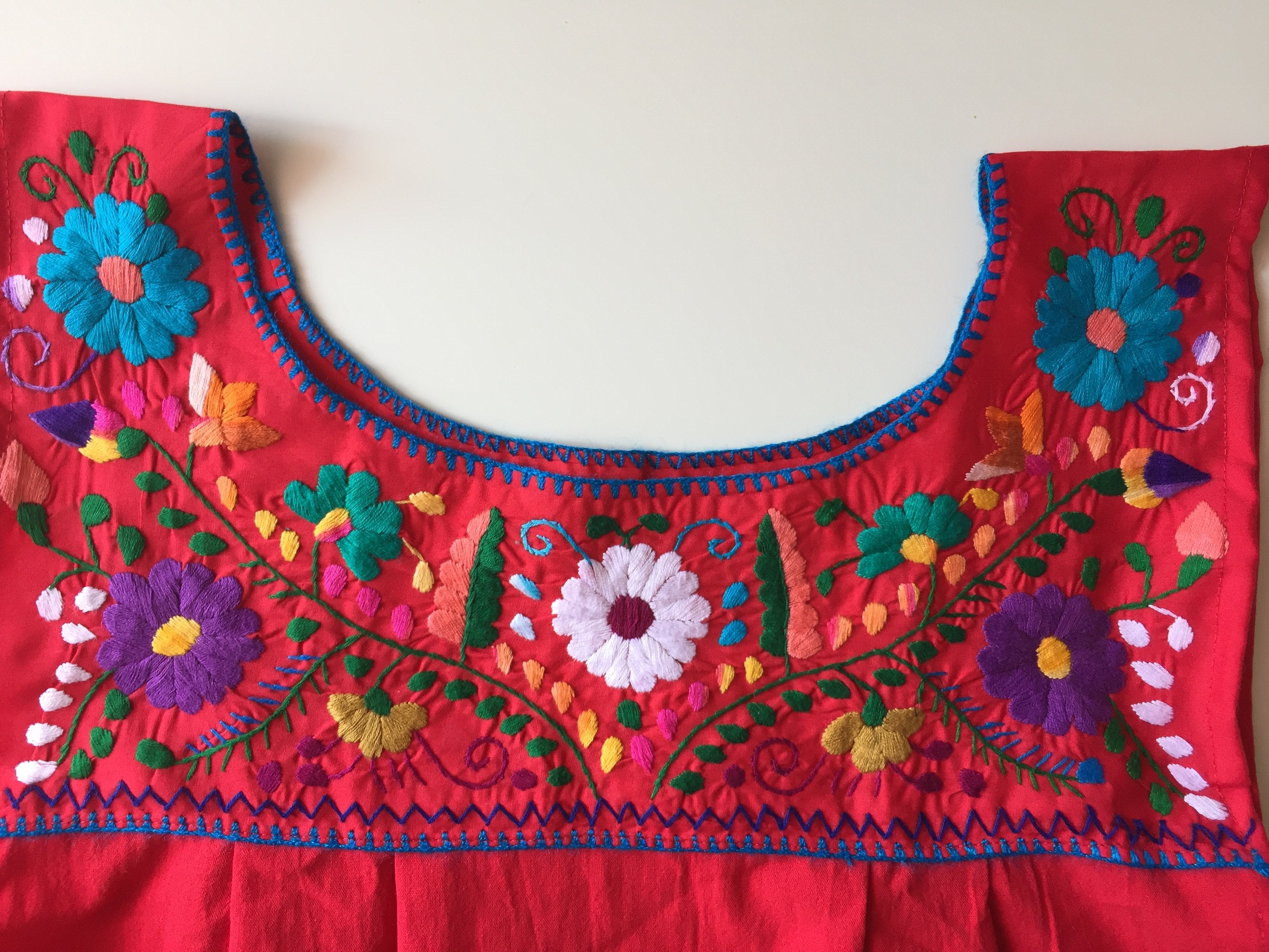 Violet Athena Maxi Isidra folk dress with embroidered flower details, featuring a flowing silhouette and vibrant floral patterns.