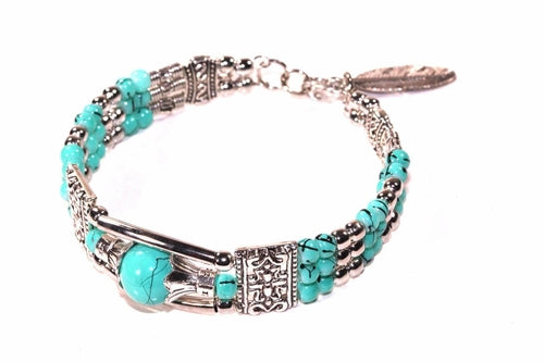 Silver Hestia feather charm and beads bracelet with delicate silver accents and intricate bead details on a soft, elegant design.