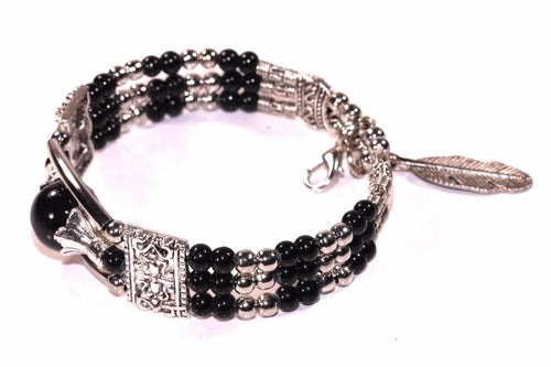 Silver Hestia feather charm and beads bracelet with delicate silver charms and colorful beads on a black background.