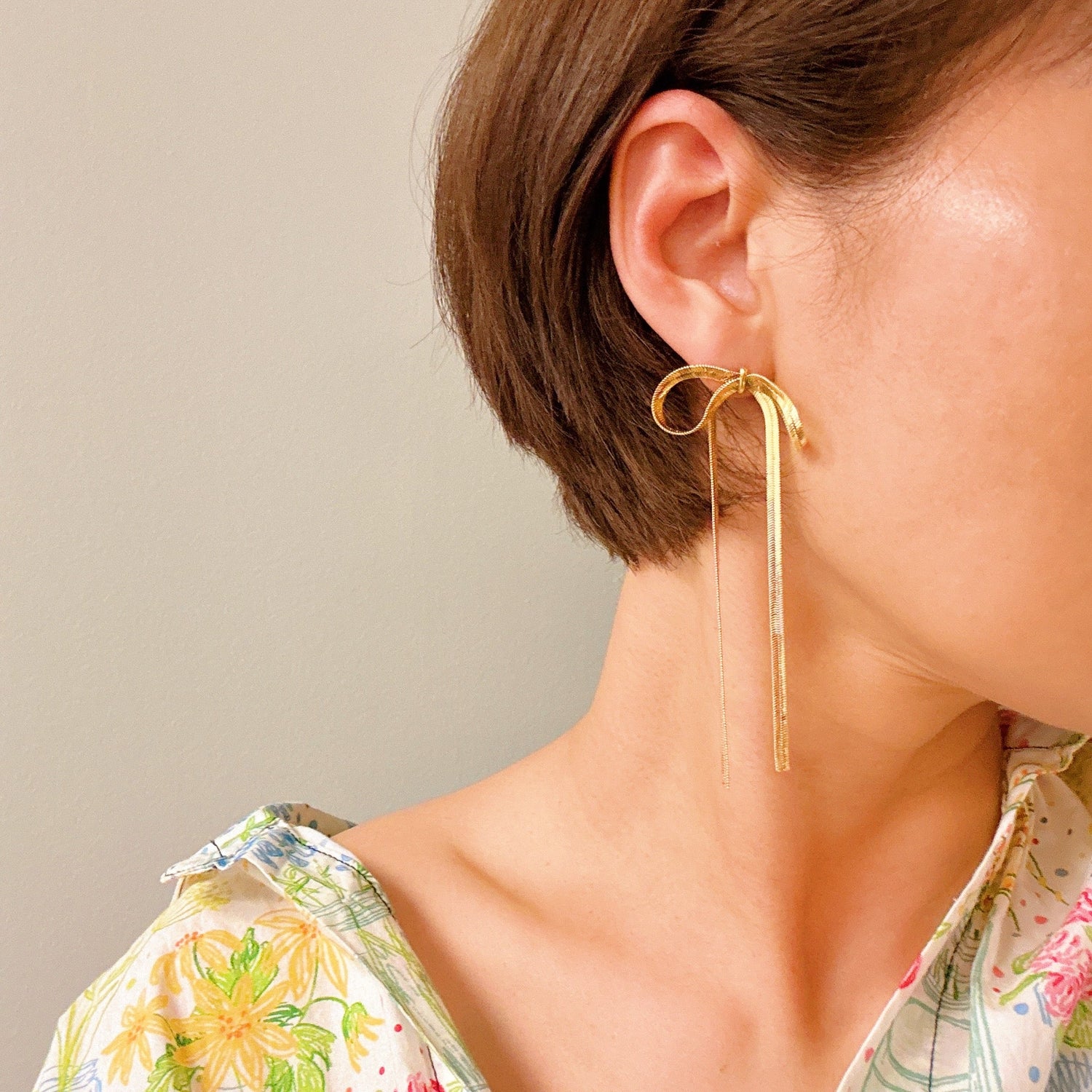 Fuchsia Hercules long drop bow earrings with elegant design and gold-tone finish, showcasing jewelry and watch accessories.