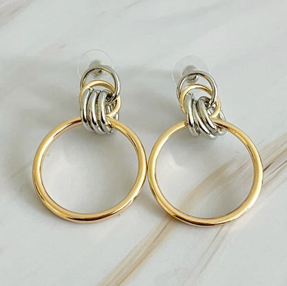 Fuchsia Hercules Knock On The Beauty hoop earrings, gold-tone jewelry with a sleek hoop design, worn on a model.