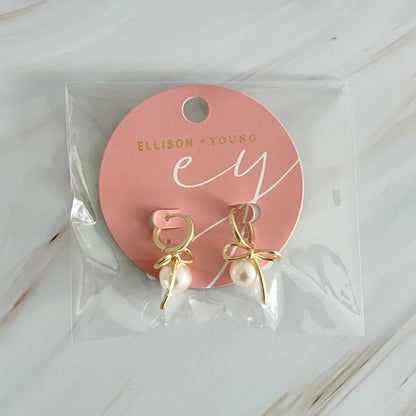 Fuchsia Hercules bowed pearl drop earrings featuring elegant jewelry design with lustrous pearl accents on a delicate metal setting.