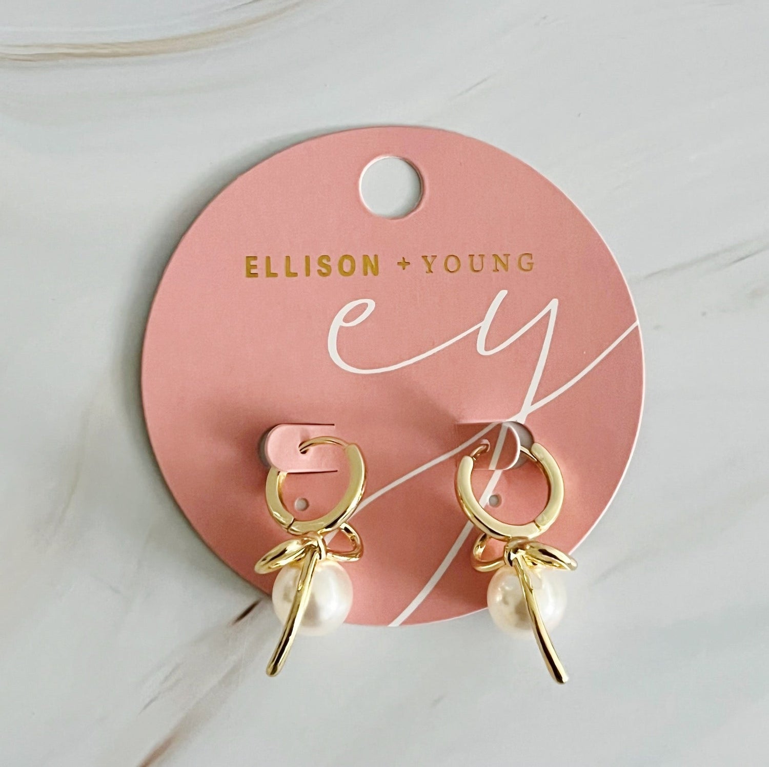 Fuchsia Hercules bowed pearl drop earrings with elegant design, featuring hanging pearl accents and a polished jewelry finish.