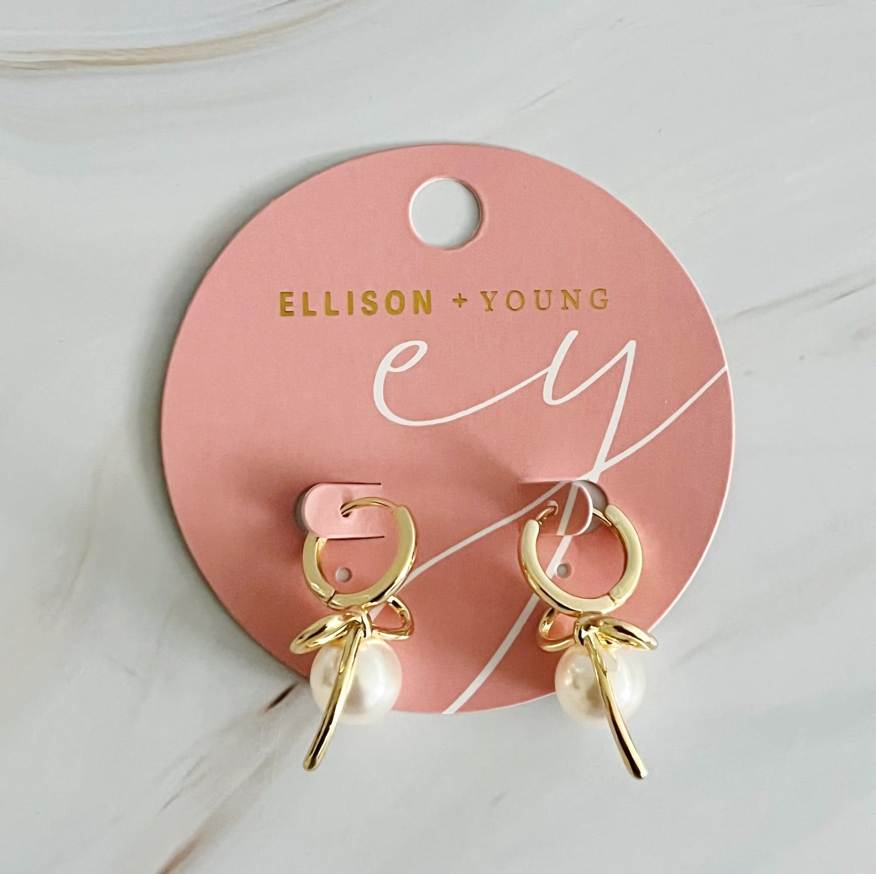Fuchsia Hercules bowed pearl drop earrings with elegant design, featuring hanging pearl accents and a polished jewelry finish.